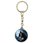 Pink Witch Keyring shows a young witch riding her broomstick with a full moon in the background
