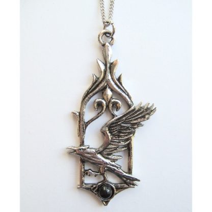The Raven Pendant shows a raven upon a black stone set into a Gothic window